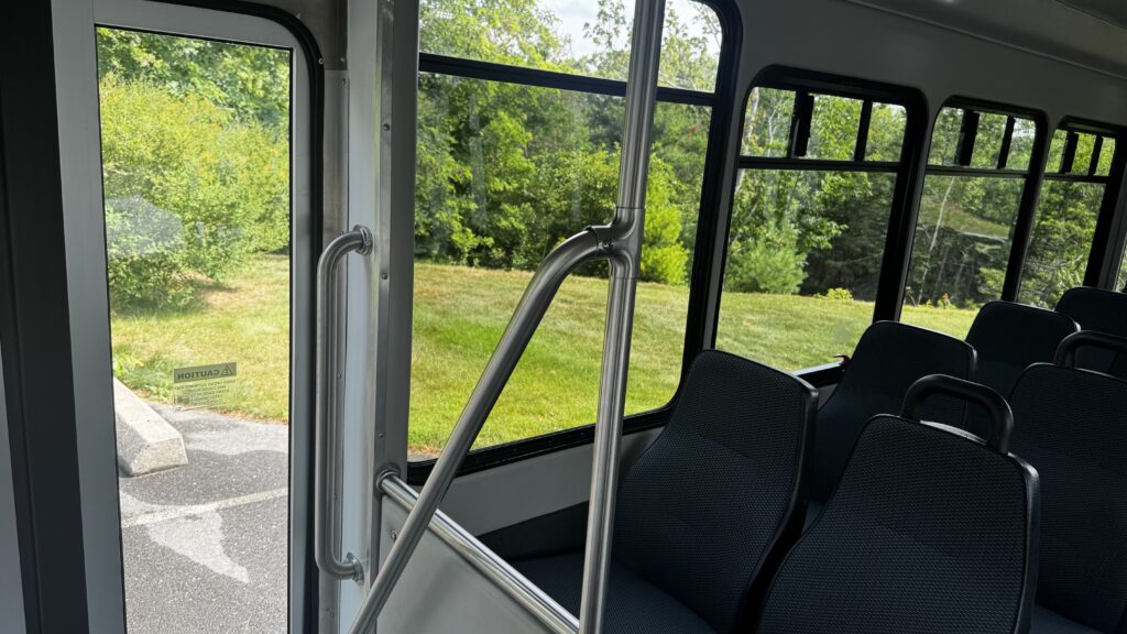 Interior of the 22-passenger Starcraft bus looking down the aisle between the seats