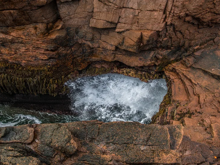 A wave surging into the narrow granite chasm at Thunder Hole