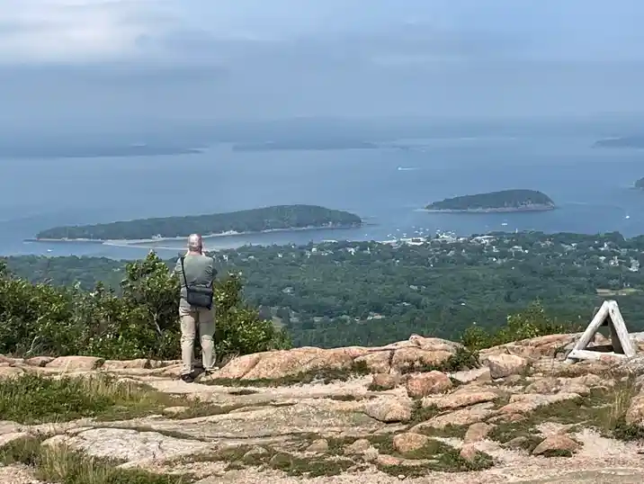 A Classic Tour guest taking in the view from the Cadillac Mountain summit